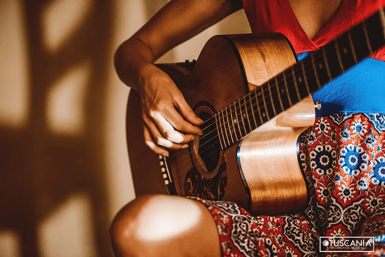 Hands on acoustic guitar strings